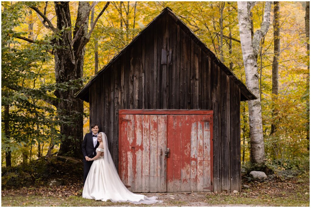 Bride and groom next to old structure 