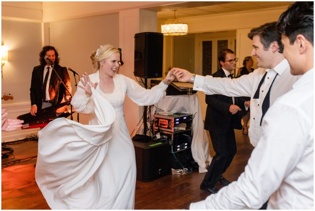Bride and groom dance with guests during open dancing at Woodstock Inn in Vermont