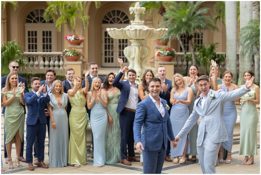 Grooms celebrating with wedding party their first look at Ritz Carlton in Naples