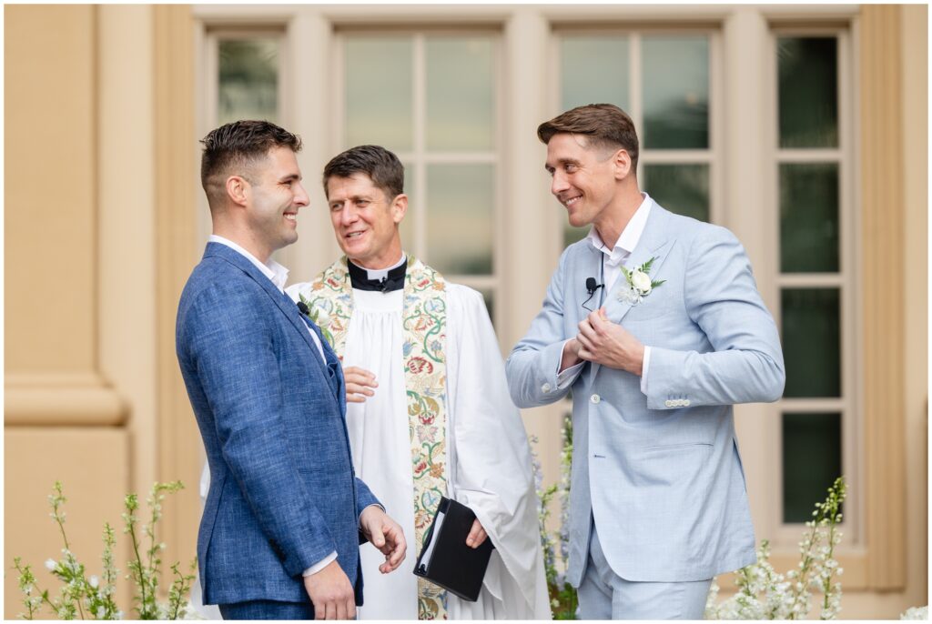 Groom reaching into his suit pocket during wedding ceremony