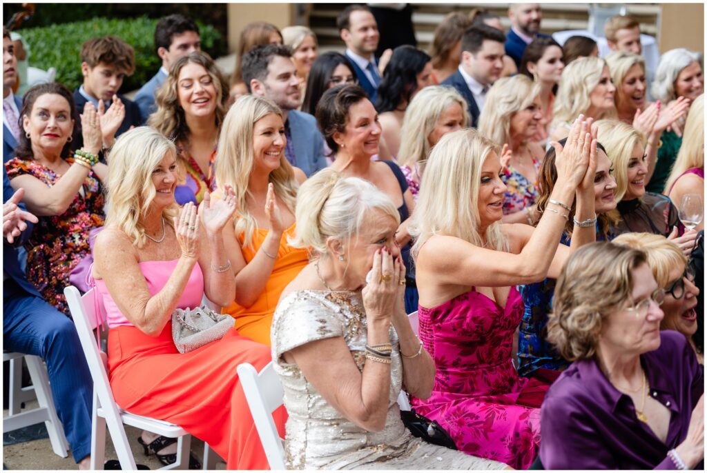 Guests cheering at end of wedding ceremony