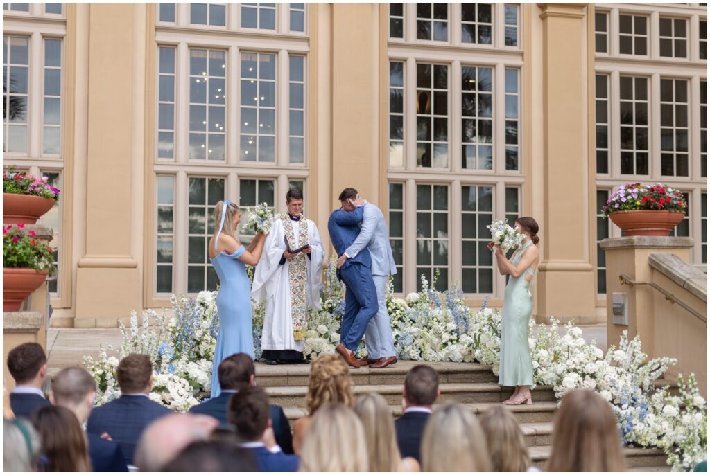 Grooms kissing at the end of wedding  ceremony at Ritz Carlton in Naples