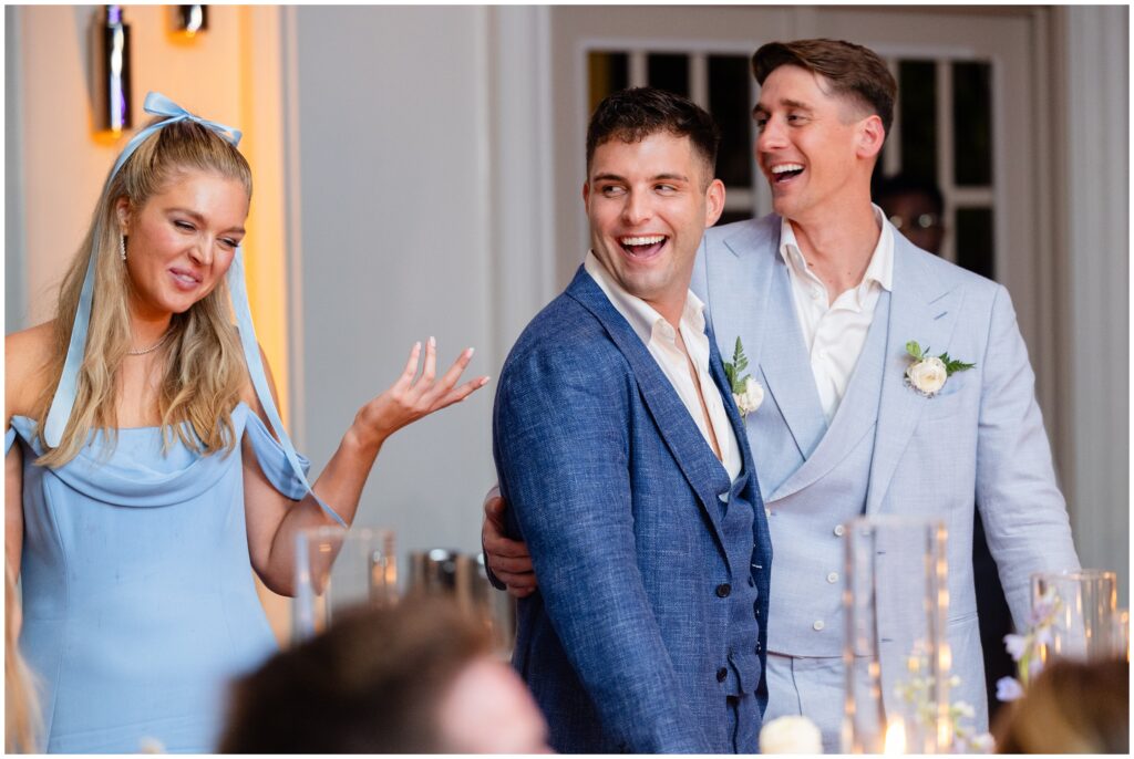 Grooms laughing during toasts at reception at Ritz Carlton in Naples