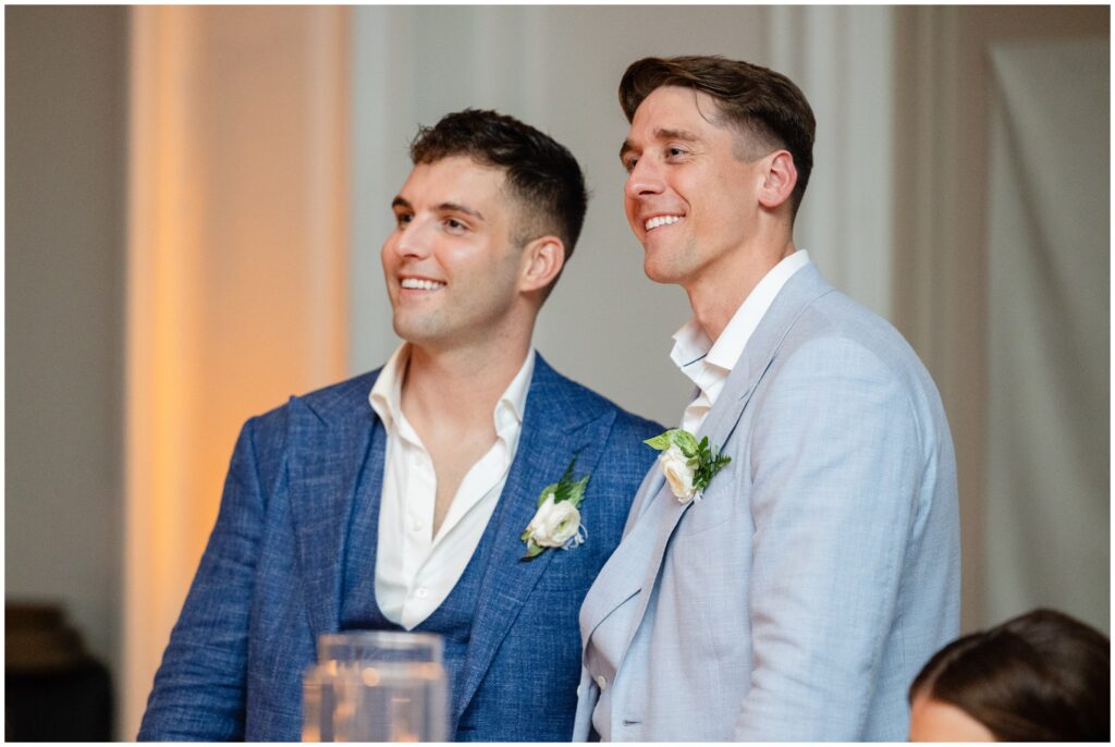 Grooms listening to speeches during reception at Ritz Carlton in Naples