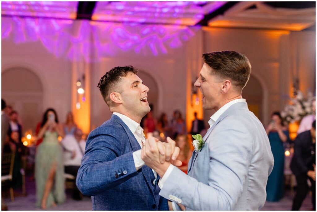 Grooms dancing together during wedding reception at Ritz Carlton in Naples