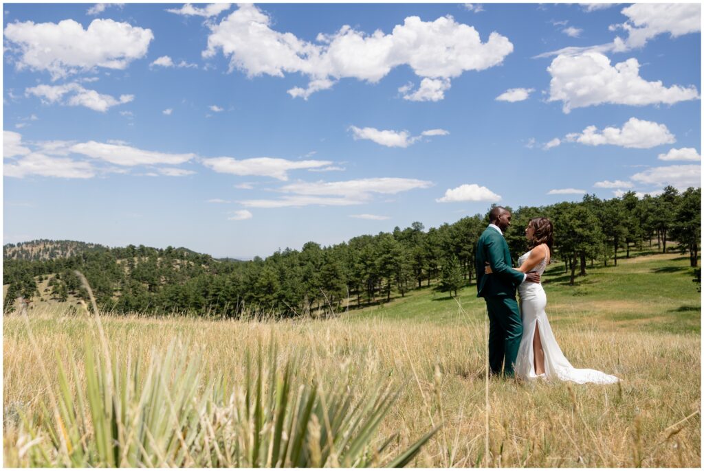 Bride and groom kiss during first look at Boulder Creek by Wedgewood