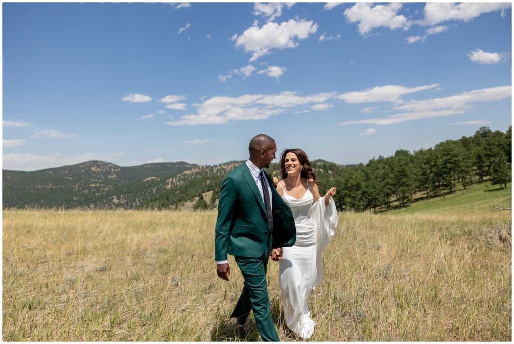 Bride and groom walking and laughing during first look at Boulder Creek by Wedgewood