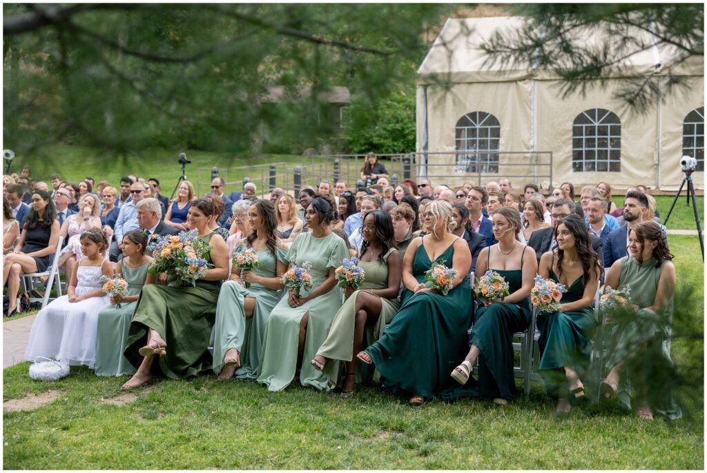 Wedding guests listening to ceremony officiant at Boulder Creek by Wedgewood