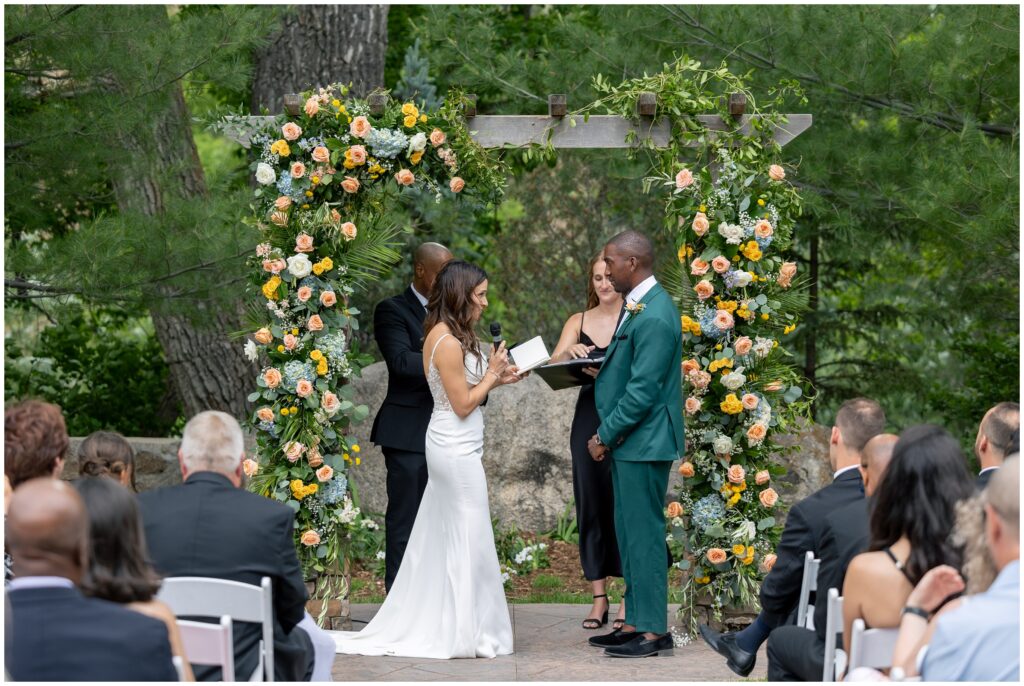 Bride reading vows to groom during ceremony at Boulder Creek by Wedgewood