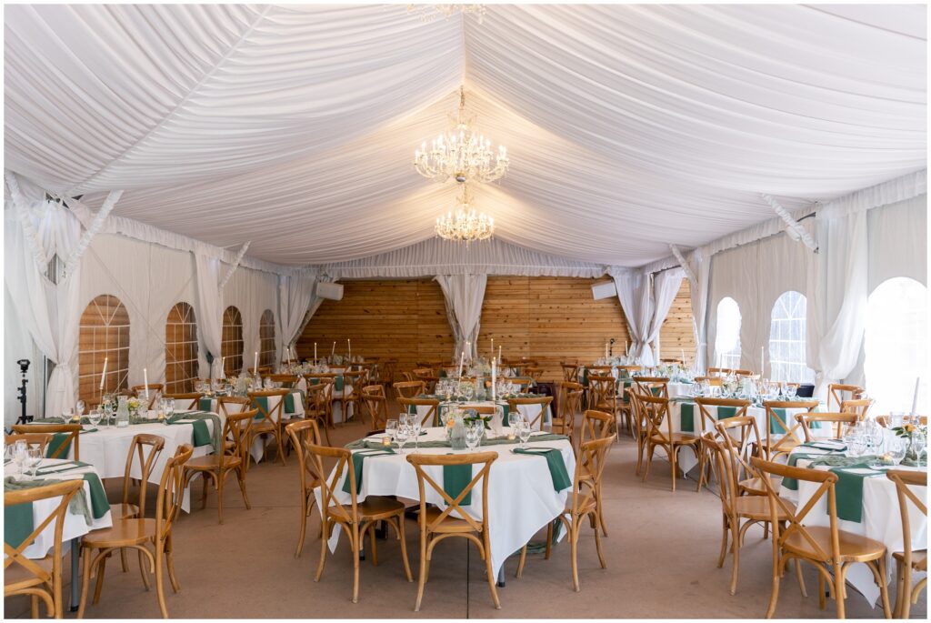 Reception area with dinner tables under tent at Boulder Creek by Wedgewood