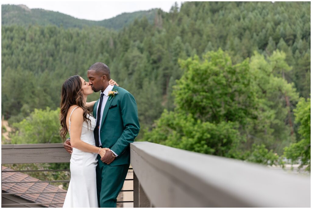 Bride and groom kiss on patio at Boulder Creek by Wedgewood