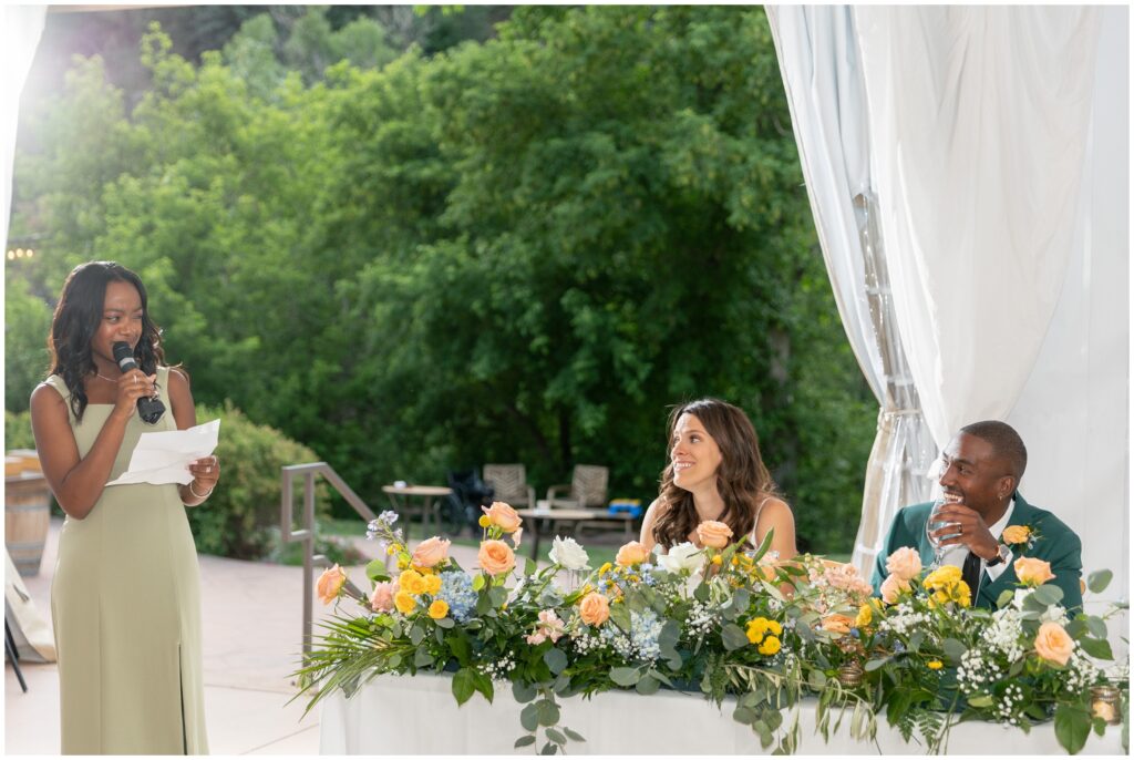 Bridesmaid giving toast to bride and groom