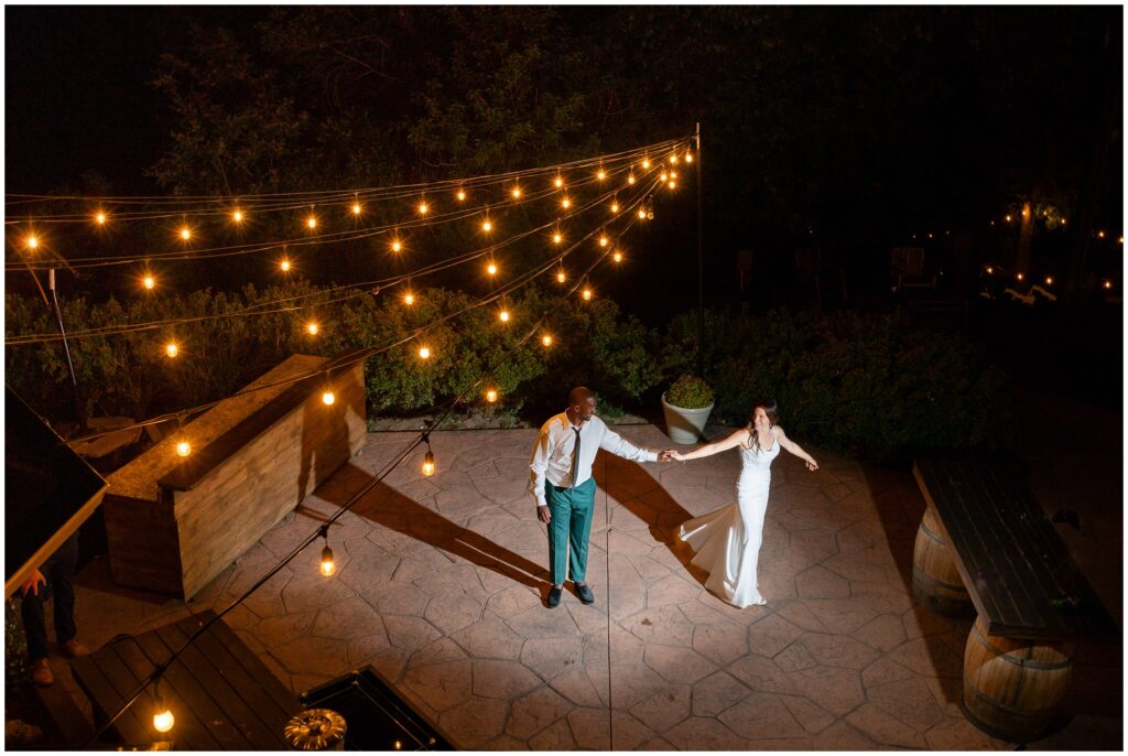 Bride and groom dancing outside under lights at Boulder Creek by Wedgewood