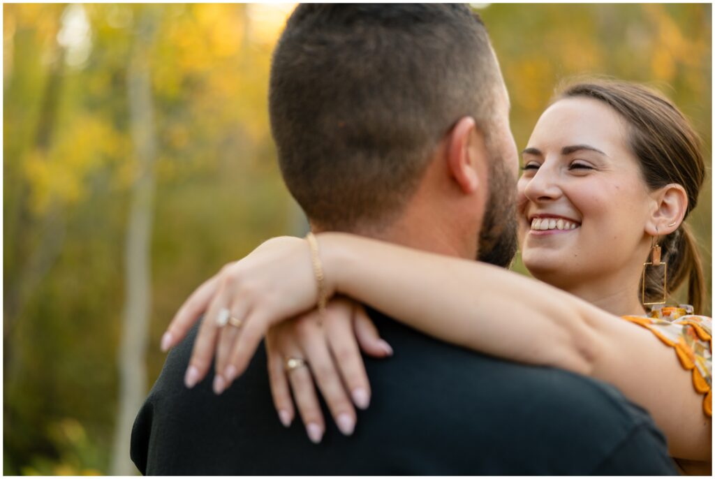 Couple hugging during Engagement session in Fish Creek Falls Steamboat Springs