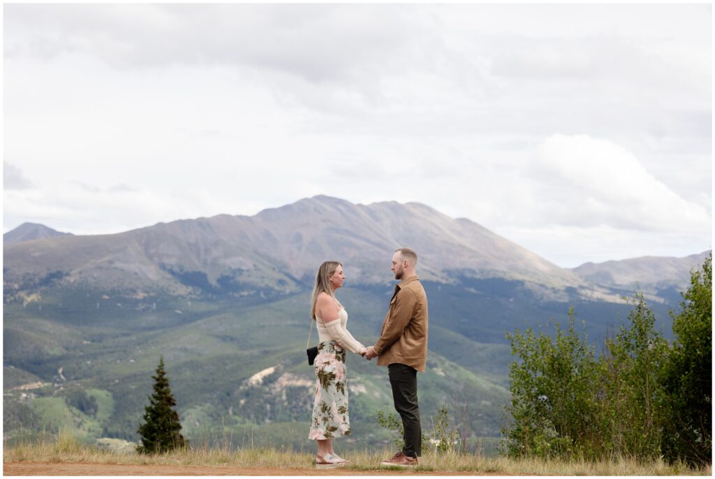 Couple holding hands on mountain top in Breckenridge