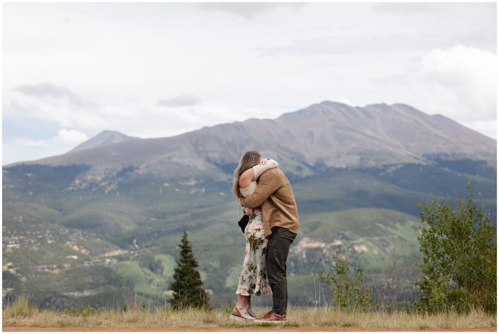 Couple hugging after proposal in Breckenridge