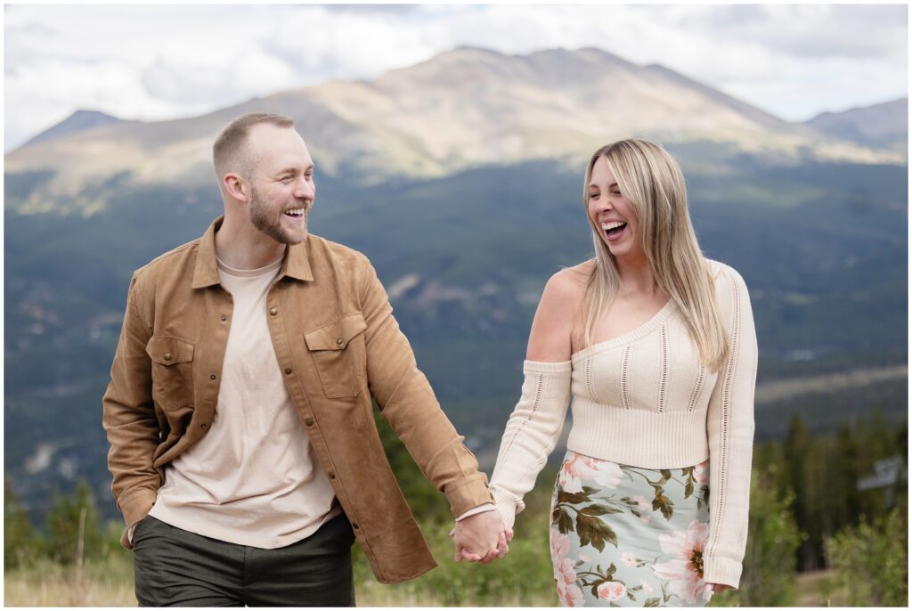 Couple walking and holding hands in Breckenridge after proposal