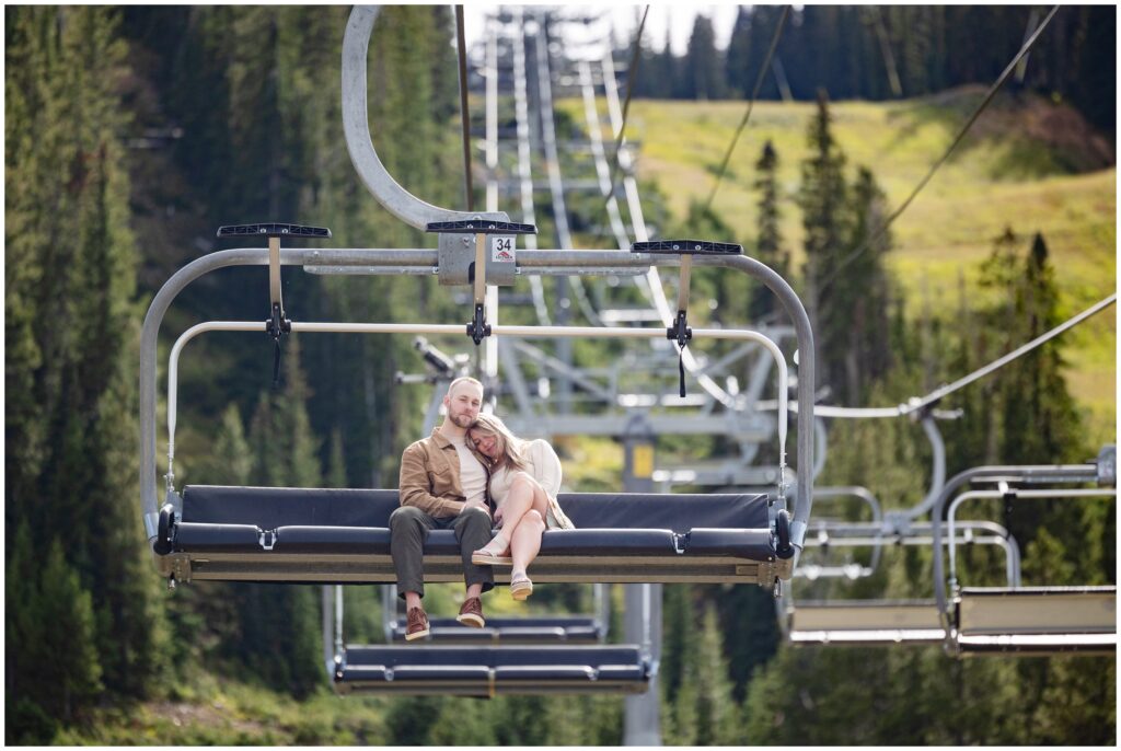 Couple going down chairlift in Breckenridge after proposal