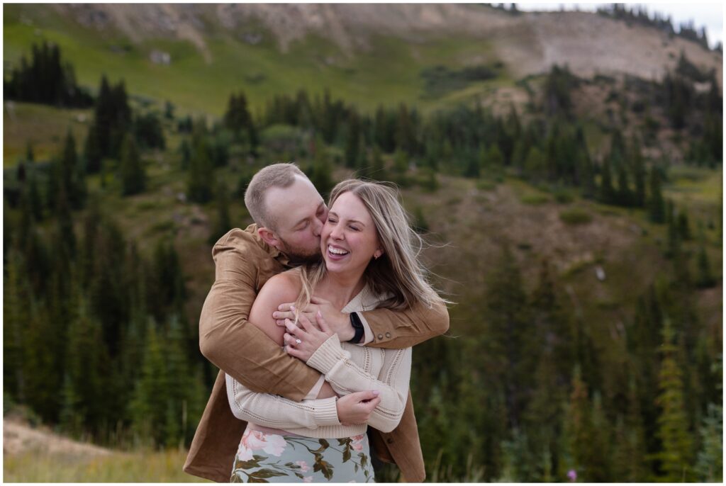 Couple hugging and laughing after proposal in Breckenridge