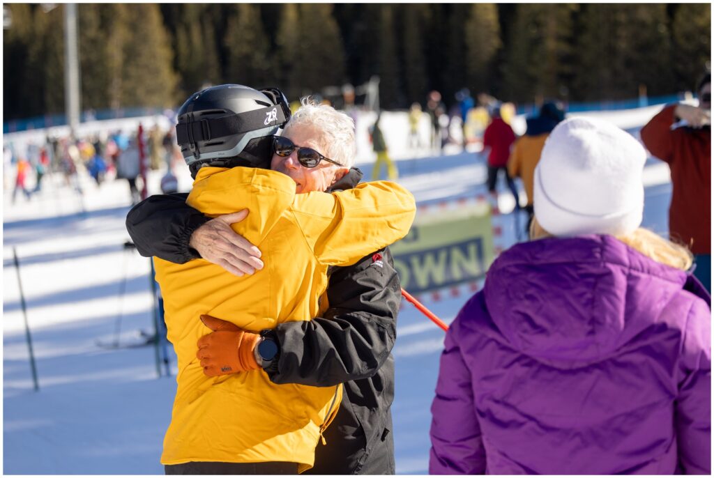 Dad celebrates with son after Breckenridge mountain ski proposal