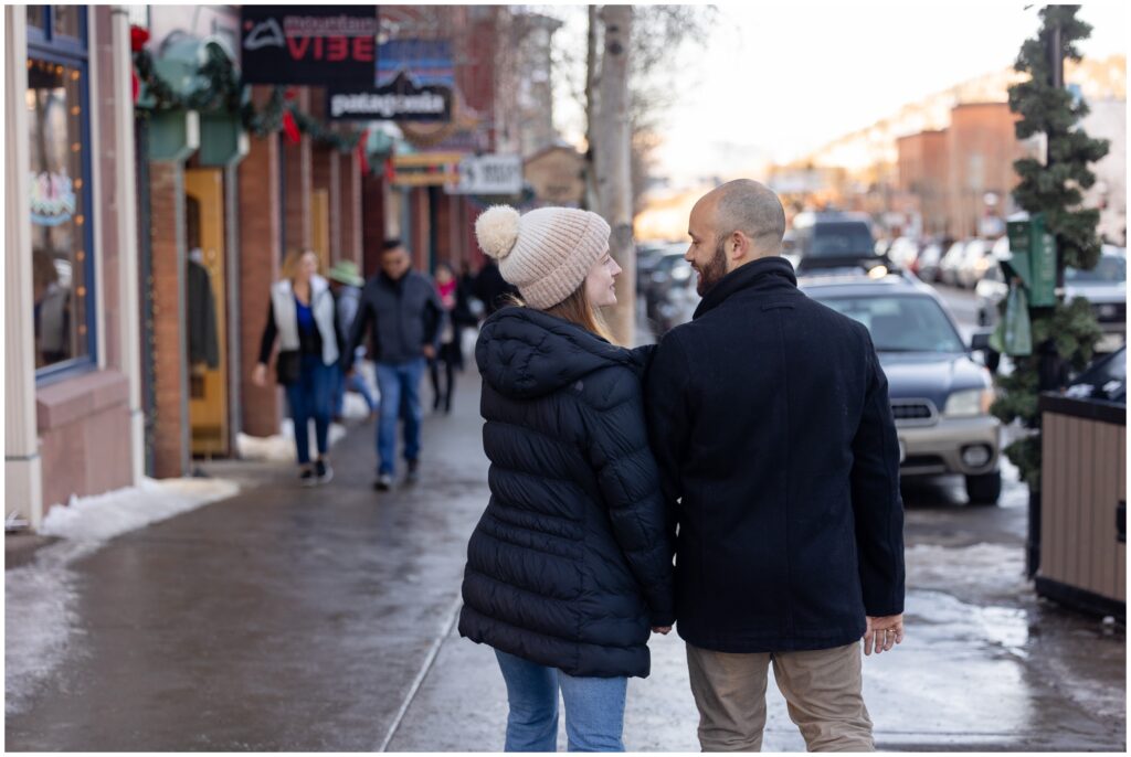 Couple walking along downtown Breckenridge after their  proposal