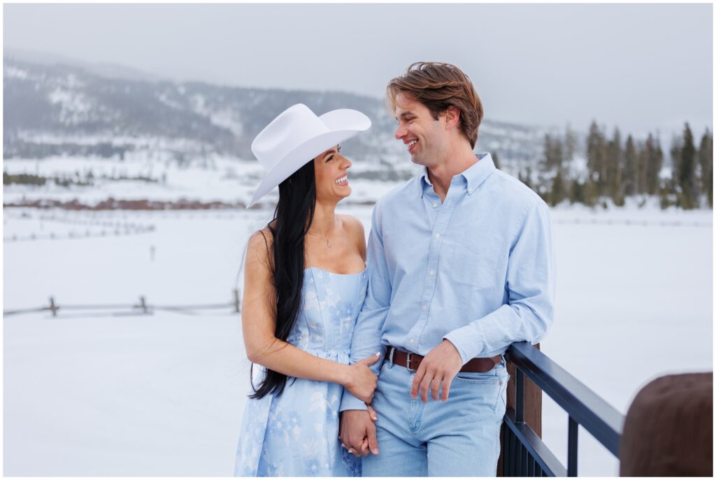 Couple leaning on bridge at Devil's Thumb Ranch