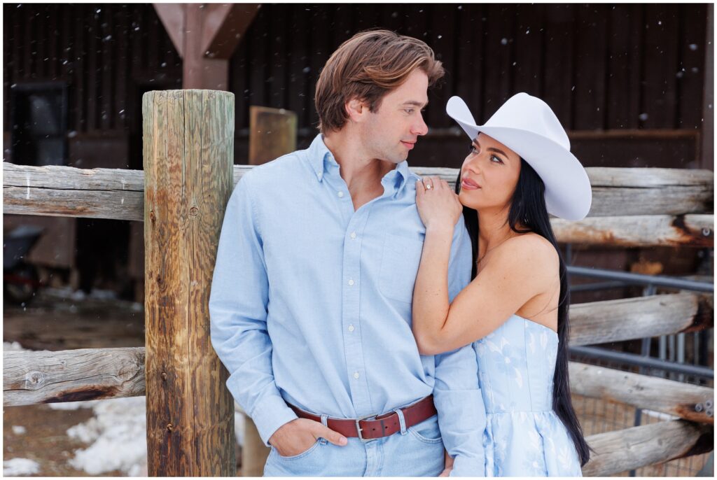 Couple outside of horse area for engagement session at Devil's Thumb Ranch