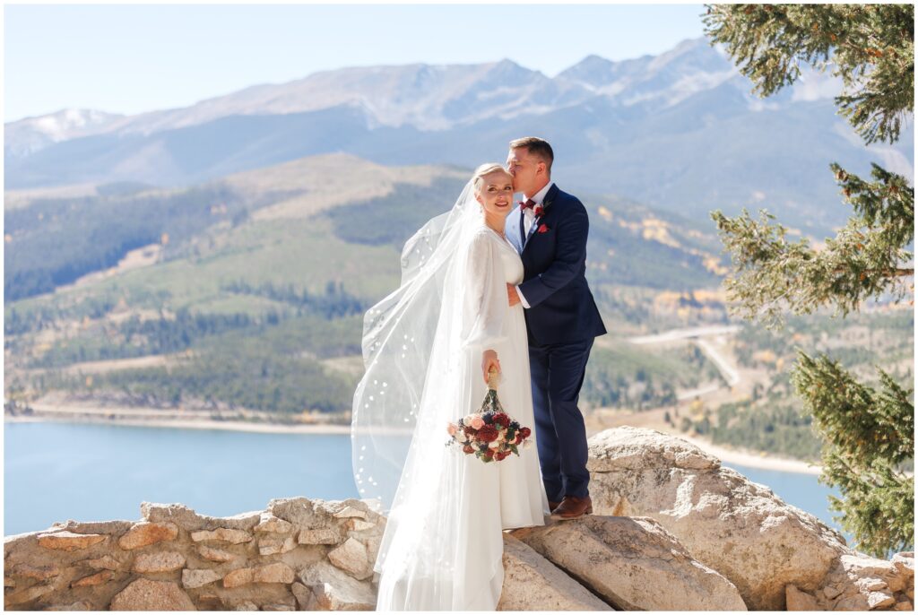 Bride and groom standing on rocks 