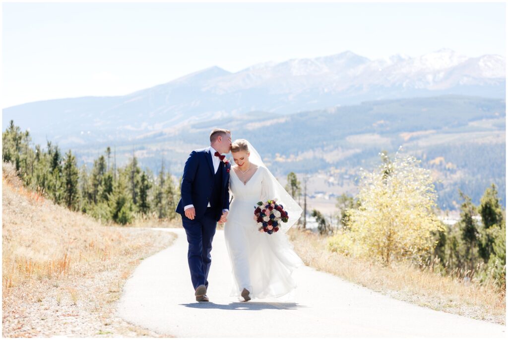 Bride and groom walking down trail