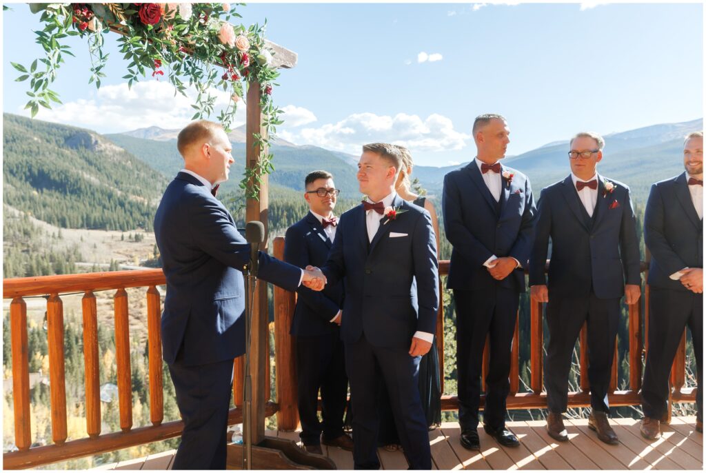 Groomsmen standing on deck at The Lodge at Breckenridge