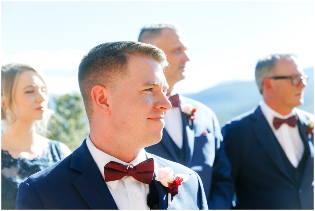 Groom looking at bride walking down isle