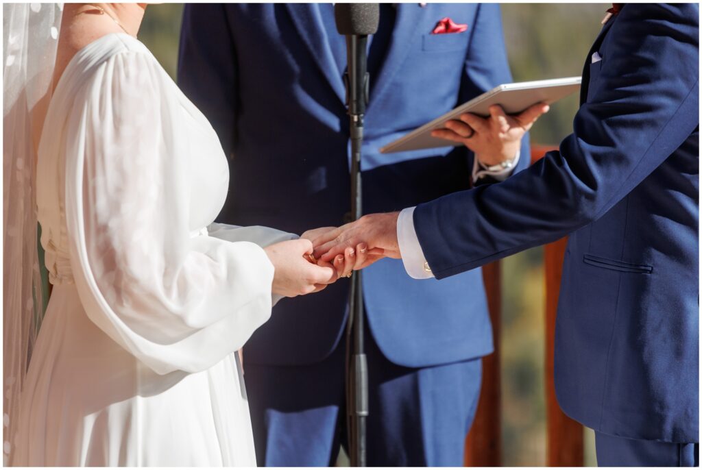 Bride and groom holding hand during ceremony