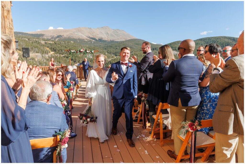 Bride and groom walking down aisle after ceremony