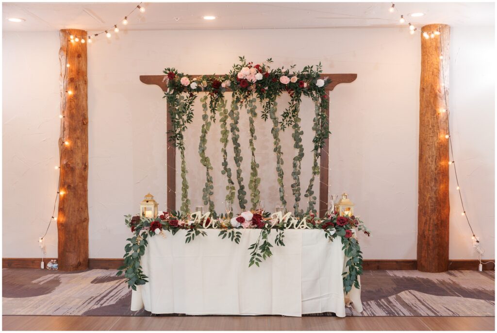 Bride and groom dinner table decorated by flowers