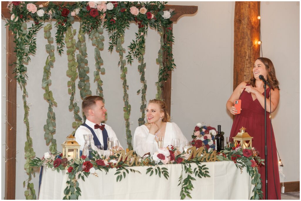 Bridesmaid giving speech to bride and groom