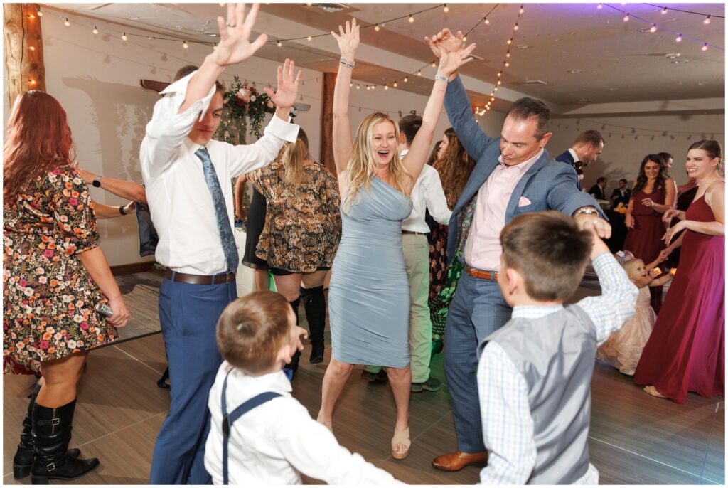 Guests celebrating with hands up in the air dancing at The Lodge at Breckenridge