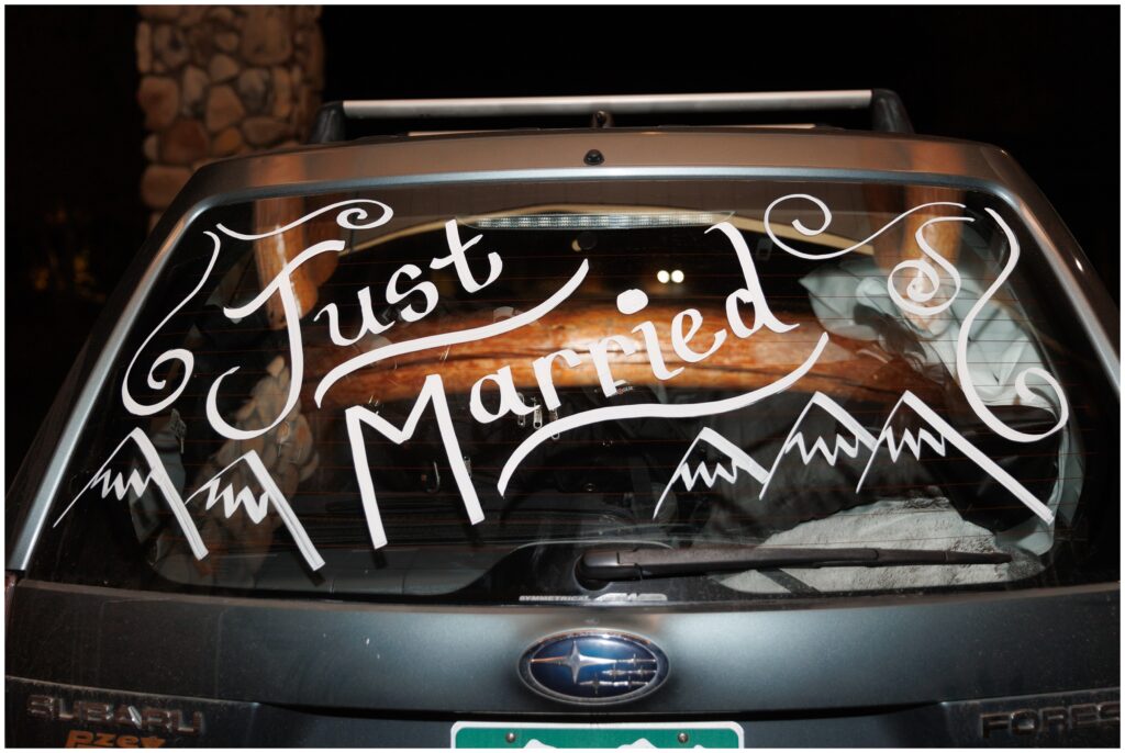 Just married sign on car departing The Lodge at Breckenridge after wedding reception 