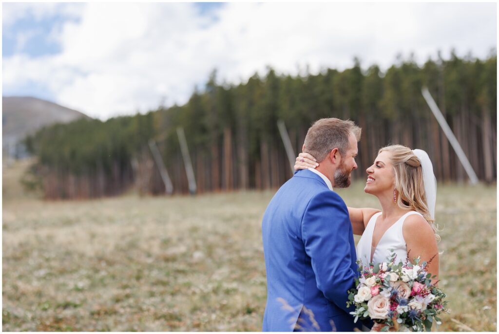 Bride and groom laughing during first look in Breckenridge