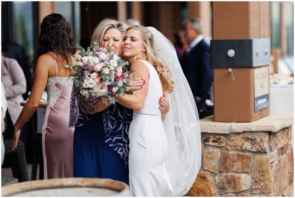 Bride hugging mom before ceremony