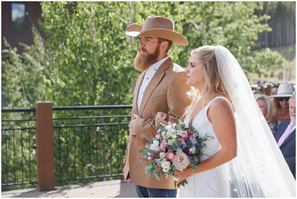 Bride walking towards groom at Sevens at Peak 7 in Breckenridge