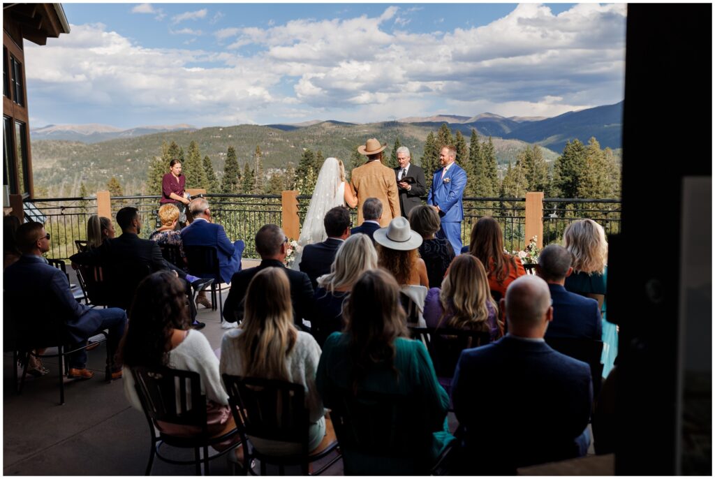 Guests watching bride walk down to see groom at Sevens at Peak 7 in Breckenridge