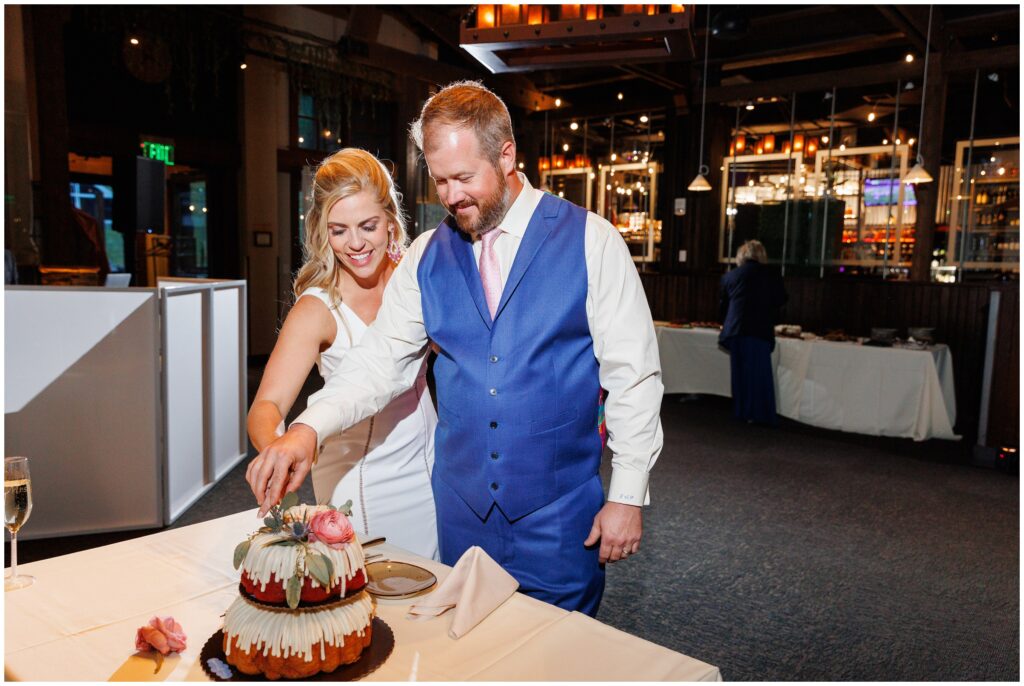 Bride and groom cutting cake provided by Nothing Bundt Cakes