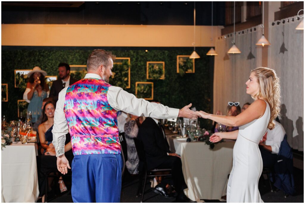 Groom swinging bride during first dance