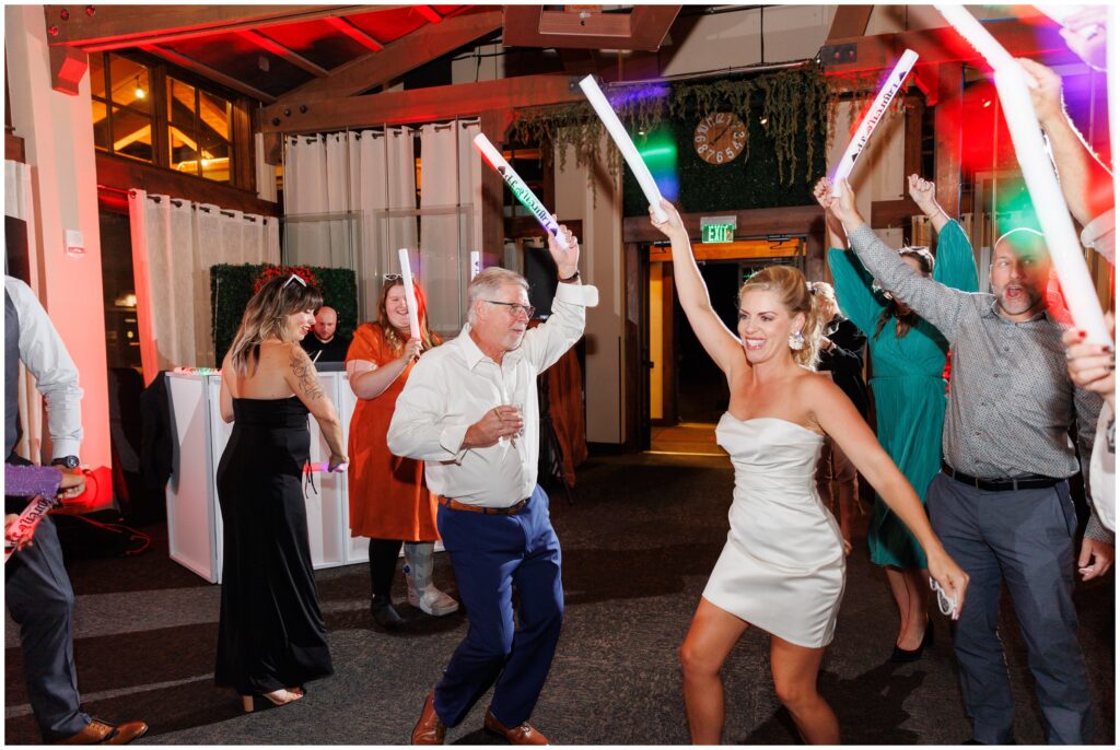 Bride and guests dancing with light sticks during open dancing inside Sevens at Peak 7 in Breckenridge