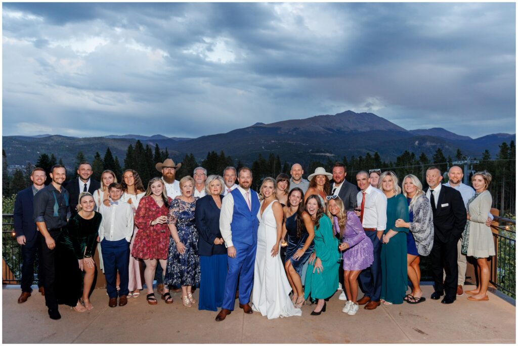 Bride and groom with guests on patio during the evening at Sevens at Peak 7 in Breckenridge