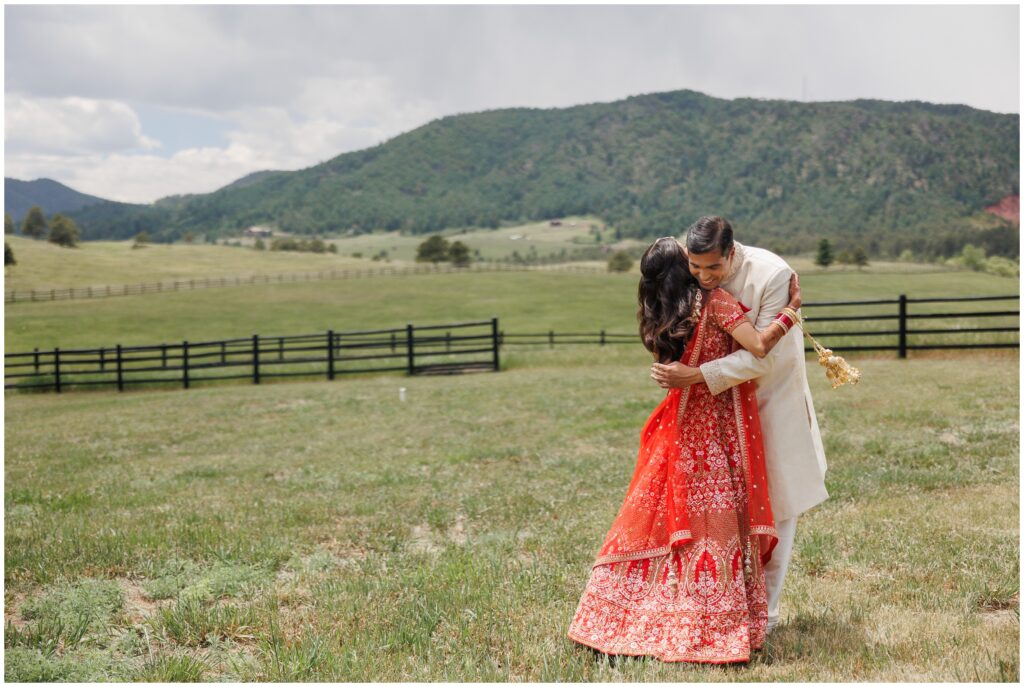 Bride and groom hugging during first look at Spruce Mountain 
