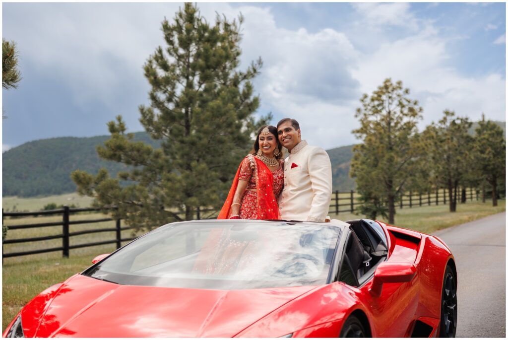 Bride and groom standing inside Lamborghini 