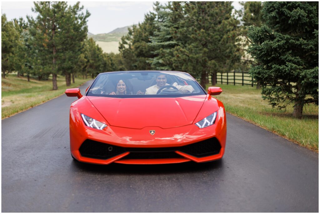 bride and groom driving in a Lamborghini at Spruce Mountain 