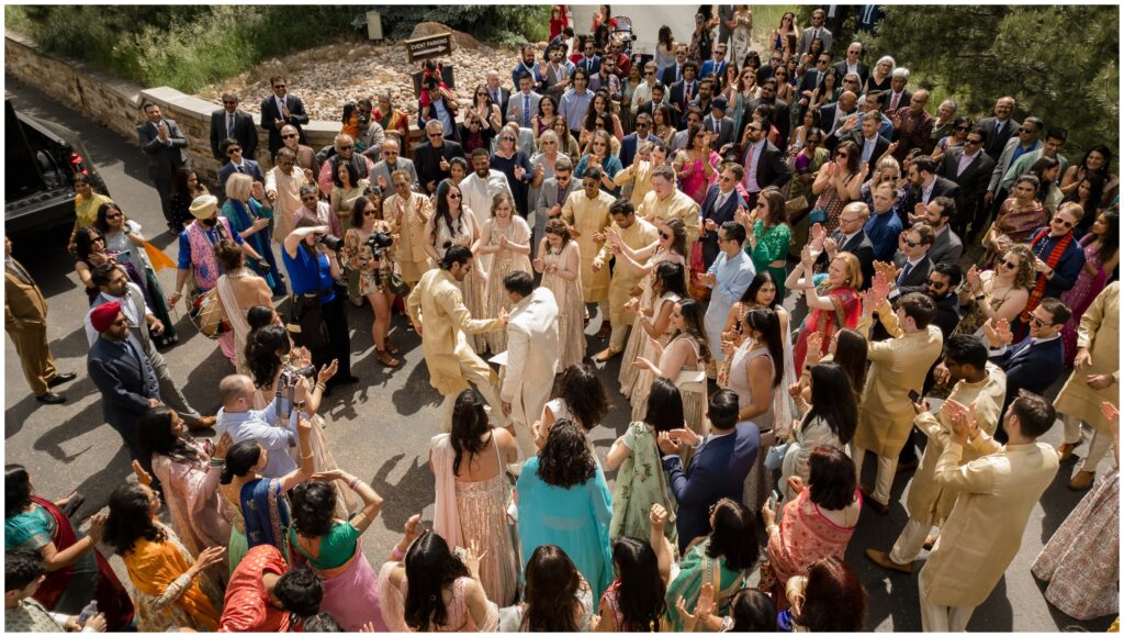 Groom celebrating with guests during baraat at Spruce Mountain 