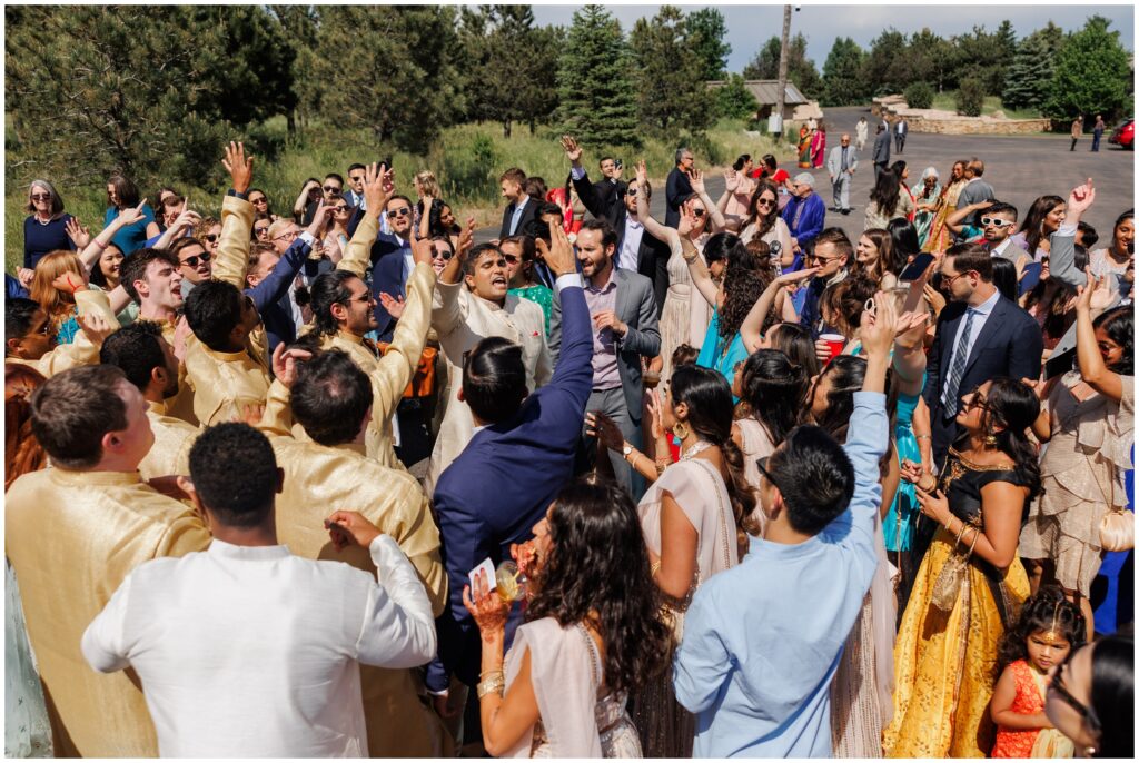 Groom and guests dancing during baraat at Spruce Mountain 